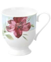 Painterly lilies bloom around this footed porcelain mug, creating a beautiful arrangement with the rest of Oleg Cassini's Sweet Blossom dinnerware.