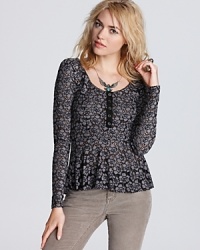 Warm up to pretty lace with this Free People top and its on-trend peplum waist.