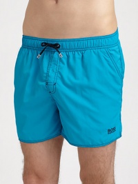 Stylish swim trunks are both sporty and functional, rendered in quick-drying nylon.Elastic drawstring waistSide slash, back flap pocketsInseam, about 4PolyamideMachine washImported