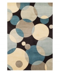 Abstract and absorbing, this rug features a multi-circle pattern in gray, taupe and an array of teal blues. Reminiscent of modern art paintings, it adds striking modernity and grace to your home. Hand-tufted and hand-carved of plush wool.