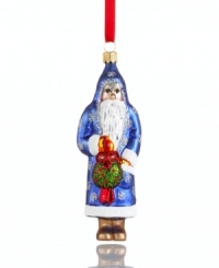 You just might catch Mommy kissing Santa Claus. With a kissing ball in-mitten, Father Christmas peers innocently out of his sparkle-studded robe in this glass Vaillancourt ornament.