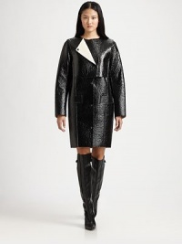 Lustrous, lacquered coat has an asymmetrical overlay, oversized sleeves and a length that hits just above the knee. RoundneckZippered asymmetrical overlayLong sleevesButton frontFront pocketsFully linedAbout 36 from shoulder to hemLacquered 90% cotton/10% viscoseDry cleanImported of Italian fabricModel shown is 5'10 (177cm) wearing US size 2.