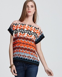 A bold geometric print infuses this Sam & Lavi top with idiosyncratic style while an exposed back zip adds edge.