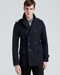 Burberry London continues to distinguish itself with remarkably modern designs that maintain a strong connection with the classics, as for example this distinctive double-breasted coat, a rakish option for both your professional and everyday attire, detailed with leather epaulets for an extra dose of luxe refinement.