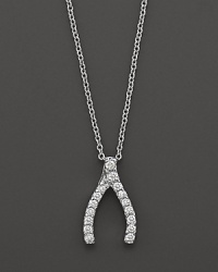 From the Tiny Treasures collection, a diamond wishbone necklace; with signature ruby accent. Designed by Roberto Coin.