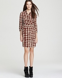 Uptown polish meets downtown edge as classic houndstooth check emboldens a contemporary Burberry Brit dress. Juxtapose the silky silhouette with chunky booties for the perfect high/low mix.