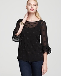 Dainty dots grace the sheer silhouette of this kate spade new york top, finished with ruffled bell sleeves for a demure yet dramatic look.