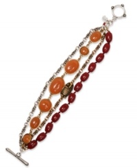 Banded together. Lucky Brand's toggle bracelet features semi-precious red and carnelian beads on a bracelet crafted from silver and gold tone base metal. Approximate length: 7-3/4 inches.