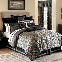 A regal damask pattern in tones of black, charcoal and tan, accented with shams and decorative pillows in rich fabrics and detailed trim create a dramatic collection. The bedskirt is in black taffeta with gold insets.