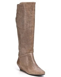 Simple but not boring. Sleek tall leather wedge booties with a asymmetrical cut top and buckle detail at back.