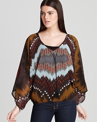 This Sanctuary blouse features stylish wide Dolman sleeves in a fluid poncho-style silhouette, embracing fall's most welcome trend of boxy tops in silky-soft fabrics.