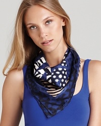 Iconic gancinis and various animal prints decorate an elegant silk scarf from Salvatore Ferragamo.