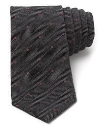 The herringbone pattern provides an unexpected but classic background for the colored dots that run across the front of this super-cool tie from Paul Smith, crafted in soft wool for a unique material presence.