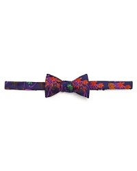 A vibrant floral print decorates fine silk on Duchamp's bowtie.