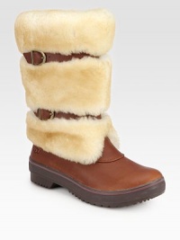 Belt-inspired straps cinch this plush shearling boot with rich leather accents. Shaft, 10¼Leg circumference, 14Shearling and leather upperPull-on style with adjustable leather strapsShearling liningRubber trek solePadded insoleImported