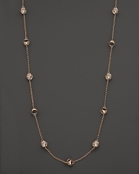 Clear rock crystal rests inside 18K rose gold stations on this modern Di MODOLO necklace.