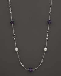 This sterling silver necklace, gleaming with amethysts and freshwater pearls, makes an elegant statement. By Di MODOLO.