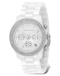 Michael Kors chronograph bracelet watch in white ceramic and stainless steel has a glammed up clear stone bezel. White dial with date display and second hand.