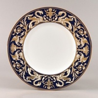 Embellished with intricate garlands, oval links and a fanciful dragon motif, this Wedgwood dinnerware evokes Europe's glorious Renaissance period. Rendered in deep blue and gold to transform any formal meal into a spectacular royal gala.