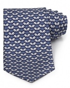 A parade of elephants are linked together by Salvatore Ferragamo's signature logos on this exceptional tie, rendered in plush Italian silk for a soft hand and luxurious refinement.