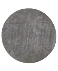 Expanding on classic rug motifs, this modern piece features a clean design of oversized leaves, virtually imprinted on an cool gray background. New Zealand wool is tufted by hand, creating a premium-quality rug with thick, dense pile.