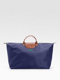 This ultra versatile tote is sized and shaped for the shopping, travel, the gym or just about anything, and crafted of silky nylon with rich leather trim.Double handles, 3½ drop Top zipper close with snap flap Inside open pocket Fully lined Nylon canvas; leather trim 28W X 15½H X 9D ImportedFOR PERSONALIZATIONSelect a color and quantity, then scroll down and click on PERSONALIZE & ADD TO BAG to choose and preview your monogramming options. 