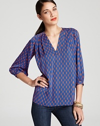 Blazing orange and brilliant blue provide a smart counterpoint to the '70s-inspired silhouette of this DIANE von FURSTENBERG blouse.