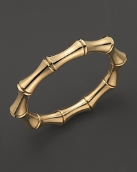 Gleaming gold imitates bamboo on Gucci's elegant bangle.