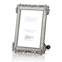 Frame timeless memories in a timeless frame. Lovely antique design of precious mother of pearl and genuine Swarovski crystals. A studded metal inset frames your greatest memories. The fully detailed metal enamel backside also features handset crystals.