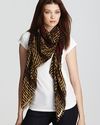 Go on an expedition in Burberry's exotic scarf, in bold shades of black and turmeric.