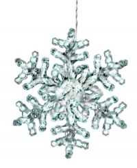 Let it glow. Twinkling clear lights fill a larger-than-life snowflake in this whimsical Christmas decoration from Kurt Adler.