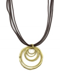 Let your sense of style come full circle. Jones New York's versatile pendant features graduated circles strung on a four-strand leather cord. Pendant and clasp crafted in gold tone mixed metal. Approximate length: 18 inches. Approximate drop: 2-1/2 inches.