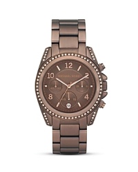 A rich espresso hue lends sophisticated shine to this stainless steel watch dial with rose-gold tone indexes and three-eye functionality. From Michael Kors.