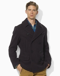 Vertical zip pockets grant a classic pea coat modern appeal in a warm wool-blend construction.