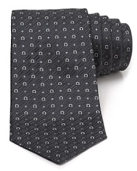 A silk tie adds distinction to your formal presentation. With a repeating pattern of Gancini logos, you'll also punch up your attire with the designer's signature flair.