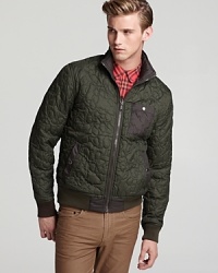 A versatile quilted jacket reverses from dark green to classic brown, providing a pair of handsome options that roll with your ever-changing needs.