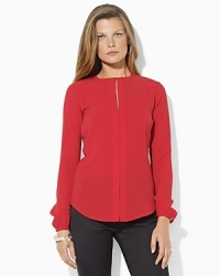 A long-sleeved blouse in a breezy silhouette is accented with a flirty keyhole opening at the front and finished with a hidden placket for a modern update to a wardrobe must-have.