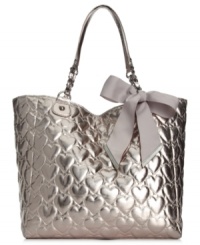 Let your look shine day and night with this shimmery metallic tote from Betsey Johnson. Spacious, pocked-lined and adorned with a sweet heart-embossed pattern topped off with a bow, it's truly scrumptious.