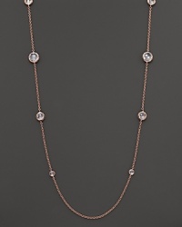 Ice-like drops of clear, bezel-set faceted quartz stud a chain of rose gold.