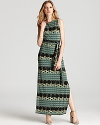 In soft, printed jersey, Ali Ro's maxi dress is sleek in a tiled print. A belted waist lends a flattering fit.