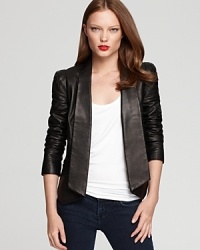 A sharp asymmetric hemline is eye-catching on this Rebecca Minkoff leather blazer, replete with puff shoulders and pleating at the elbows. A finishing touch for your cocktail silhouettes, this forward style lends modern edge to the most classic looks.