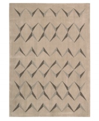 This visually arresting area rug has a simple design that casts striking shadows against a soft beige background. Hand tufted from 100% natural wool, this plush Calvin Klein rug is crafted using the cut-and-loop pile technique that creates a unique matte surface texture.