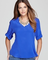 Simple and sleek, this fluid silk Amanda Uprichard top is designed with an elegant v neck and button-up sleeves.