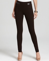 A cornerstone to city-chic style, these MICHAEL Michael Kors pants boast vertical seaming for a lithe, leg-lengthening effect. Leather bands finish the sleek silhouette for pure urban attitude.