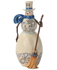 Brilliant blue details light up this folksy snowman. With broom in hand and windswept scarf around his neck, this figurine adds new personality to the season.