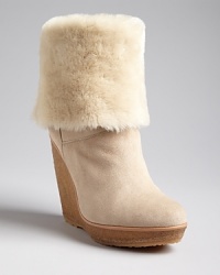 Warm and fleecy with genuine shearling, these stylish KORS Michael Kors platform wedge booties are stylish enough for a fashion runway but low-key enough for the weekend.