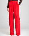 Wow the crowd in a red haute pair of REISS trousers. Add sky-high heels, and these pleated wide leg pants will elongate legs above and beyond.