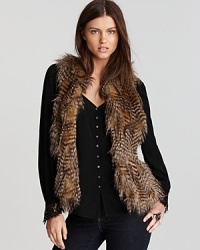 Brimming with exotic appeal, this Karen Kane faux fur vest layers over everyday staples for a sophisticated statement.