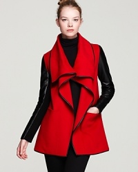 Vibrant color and trend-setting design perfectly balance on this red haute Mackage draped coat, embellished with glossy leather sleeves and piping.