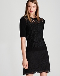 A sheer lace front lends provocative edge to a black DKNY sweater. Team with dark denim and sleek heels for an after-hours ensemble brimming with dark romance.